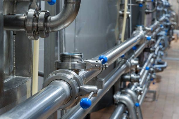 Stainless-steel industrial piping with valves and clamp fittings